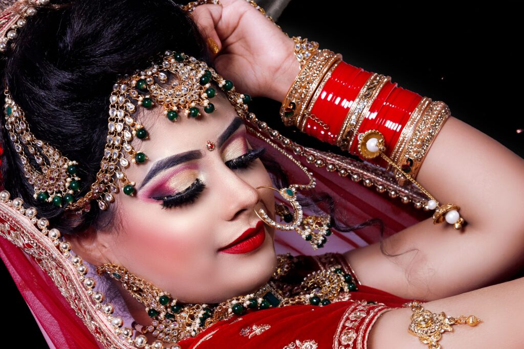 Close-up of an Indian bride showcasing ornate jewelry and vibrant traditional attire.